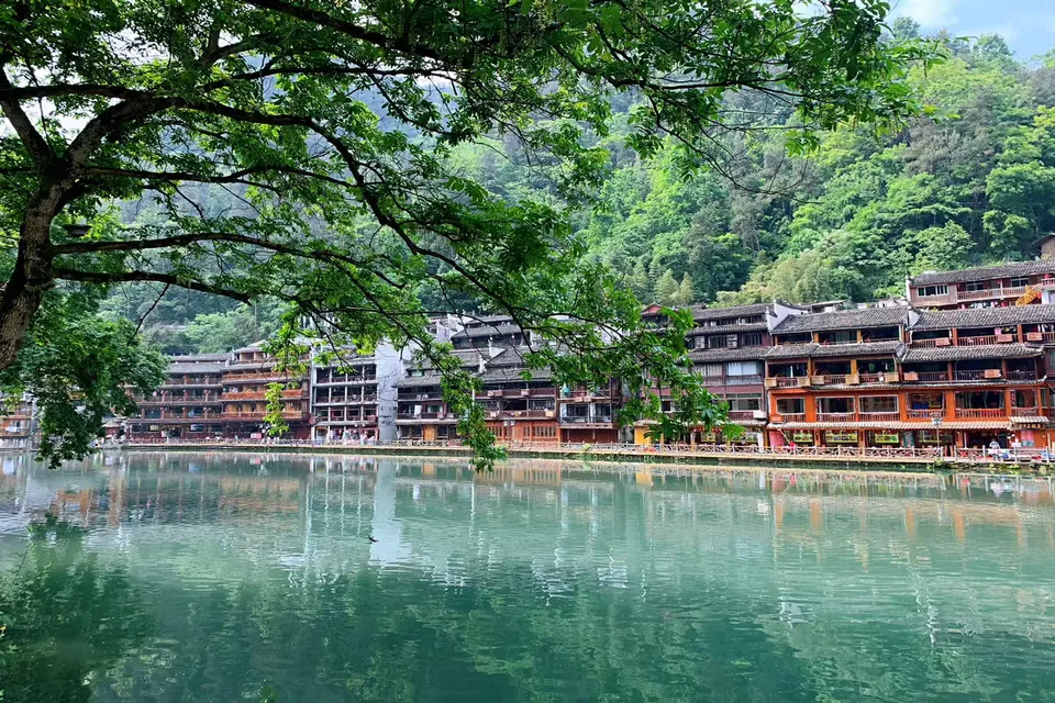 Private guide exploring Fenghuang Ancient Town night riverside
