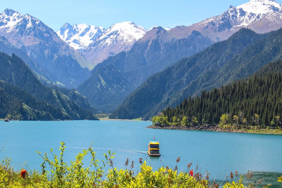 Tianchi Heavenly Lake with snow-capped mountains and clear alpine water in Xinjiang