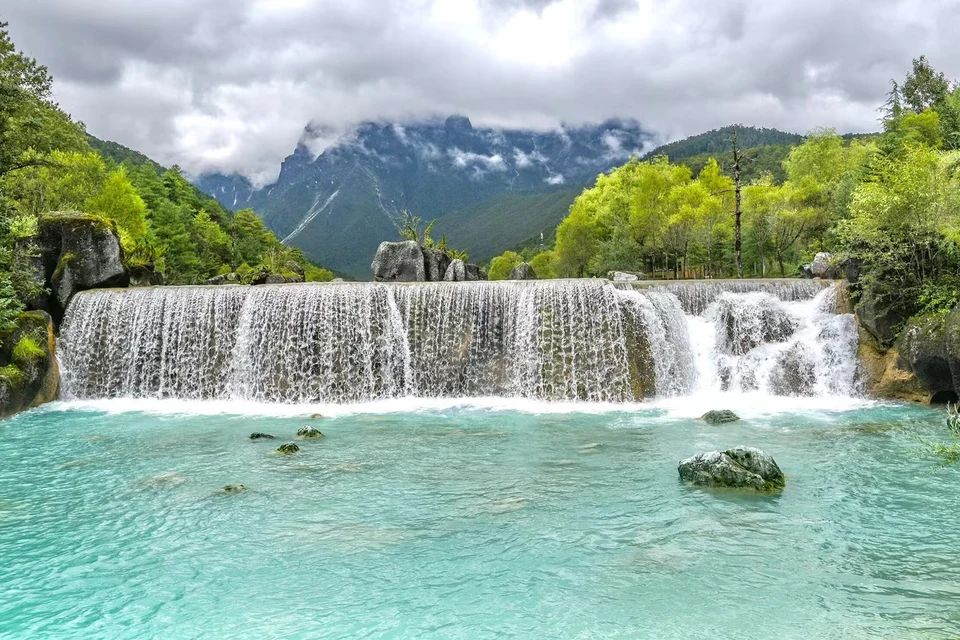 Private tour landscape of Jade Dragon Snow Mountain and Blue Moon Valley in Yunnan with alpine scenery and bright blue water