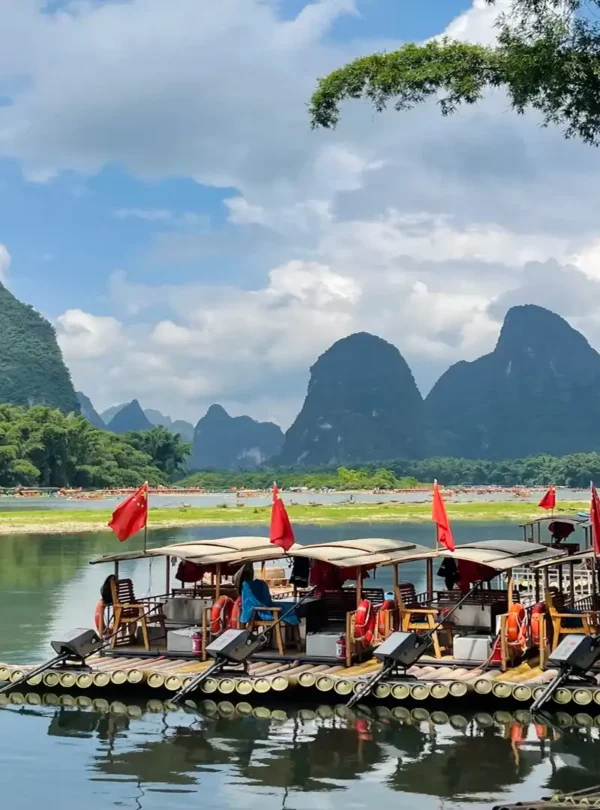 Private tour hero image of bamboo rafting on Yulong River in Yangshuo with countryside and karst peaks