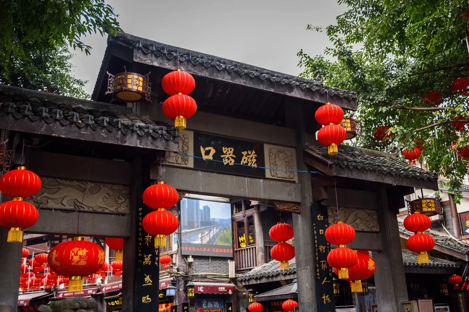 Private tour travelers exploring Ciqikou Ancient Town in Chongqing with traditional streets, shops, and local culture