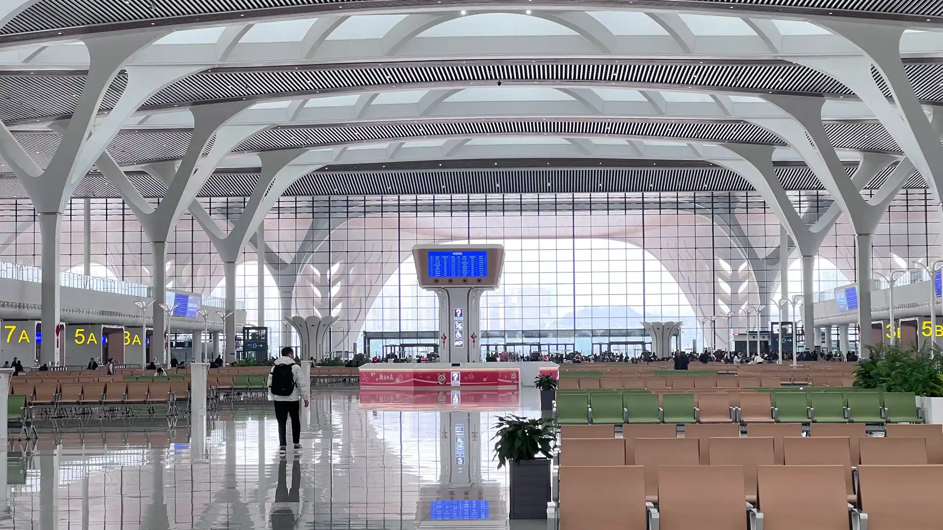 First-time traveler checking boarding information inside a China high-speed railway station