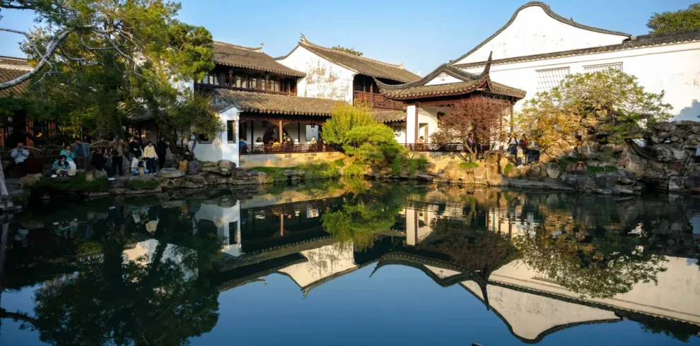 Classic East China travel scene combining gardens, lakes, and historic city heritage.