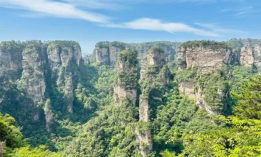 Avatar-like sandstone pillars in Zhangjiajie rising through misty mountain scenery.