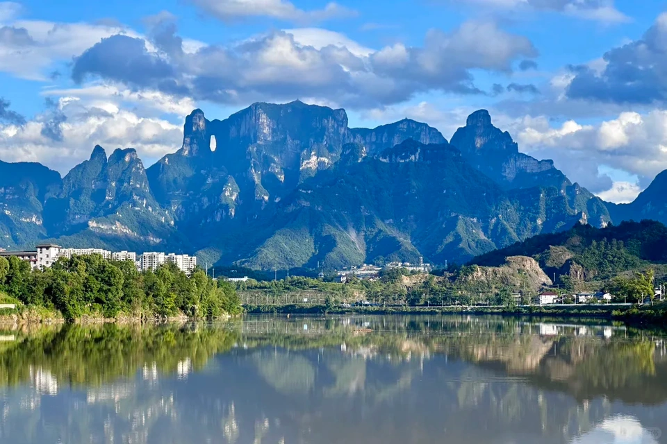 Zhangjiajie scenic wonders including sandstone peaks, glass bridge, and mountain lakes.